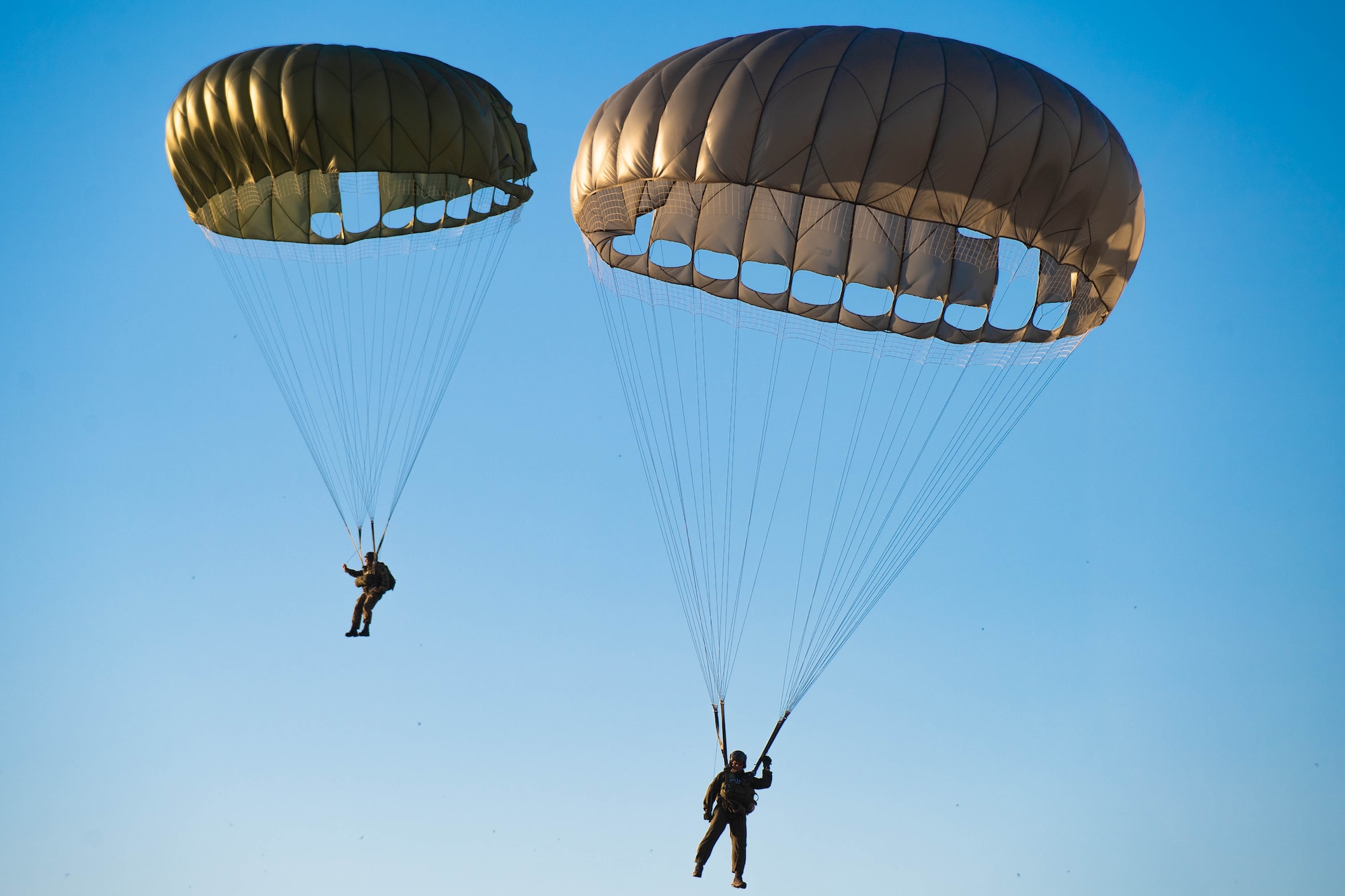 Paratroopers descend to the ground.