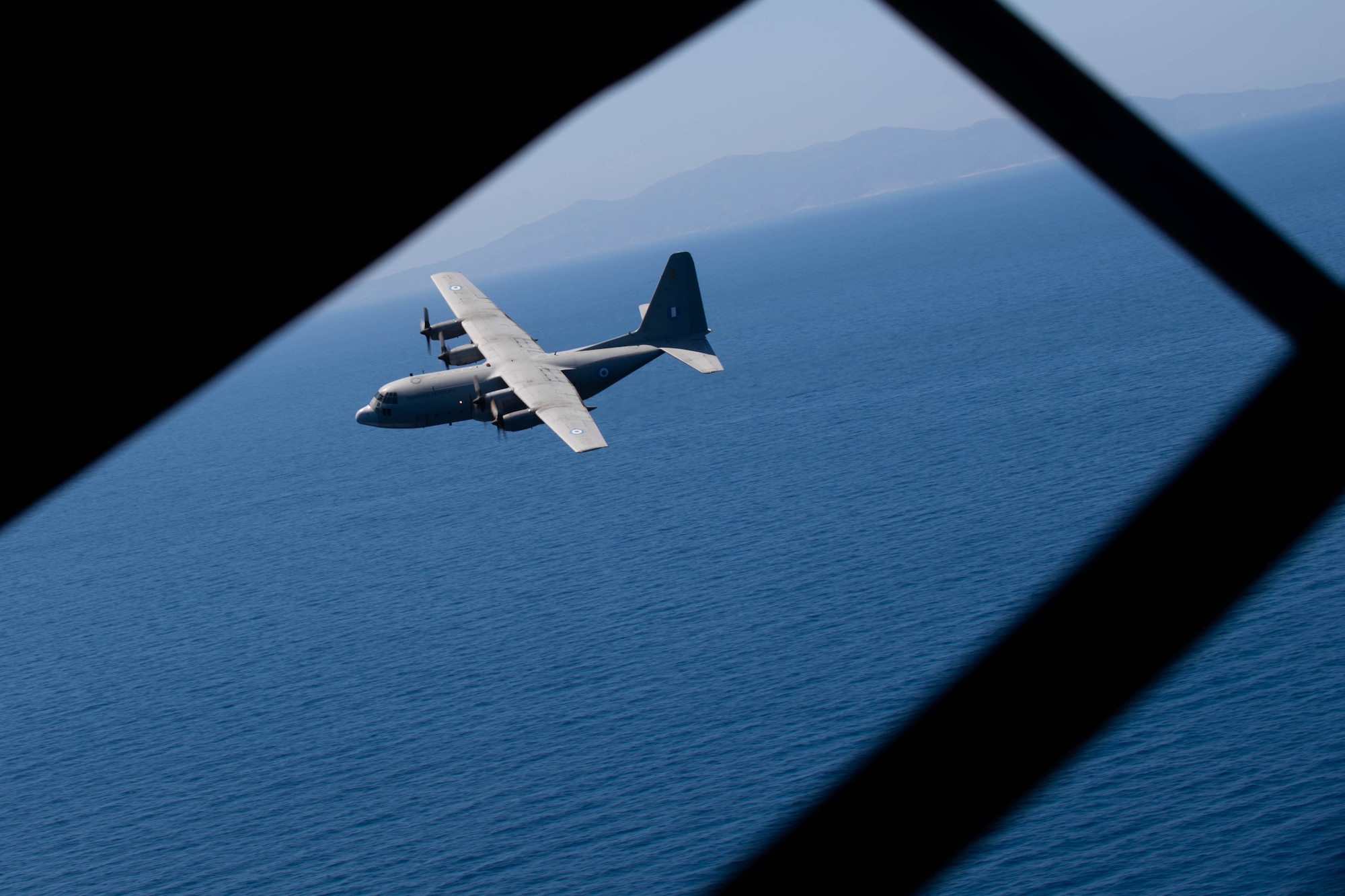 An aircraft flying over water.