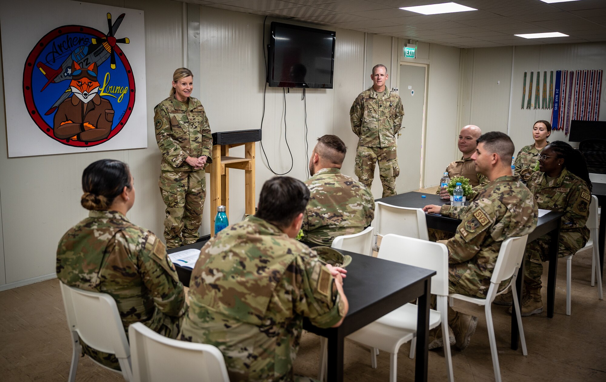 Colonel Amy Boehle, left, senior Air Reserve Component advisor for Ninth Air Force (Air Forces Central), and Lt. Col. W. Sterling Anderson II, deputy ARC advisor, talk with Guard and Reserve Red Tails from the 332d Force Support Squadron during a visit to the 332d Air Expeditionary Wing May 20, 2022, at an undisclosed location in Southwest Asia. (U.S. Air Force photo by Master Sgt. Christopher Parr)