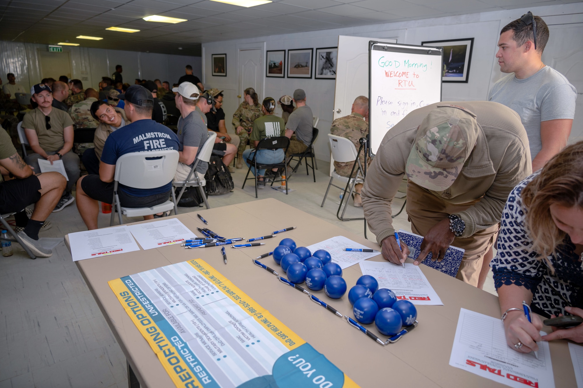 332d Air Expeditionary Wing Airmen sign in for a Red Tails University class at an undisclosed location in Southwest Asia, May 21, 2022. The curriculum options RTU provides is meant to encourage 332d AEW Red Tails to seek learning and personal growth opportunities beyond textbook-style professional military education. (U.S. Air Force photo by Tech. Sgt. Lauren M. Snyder)