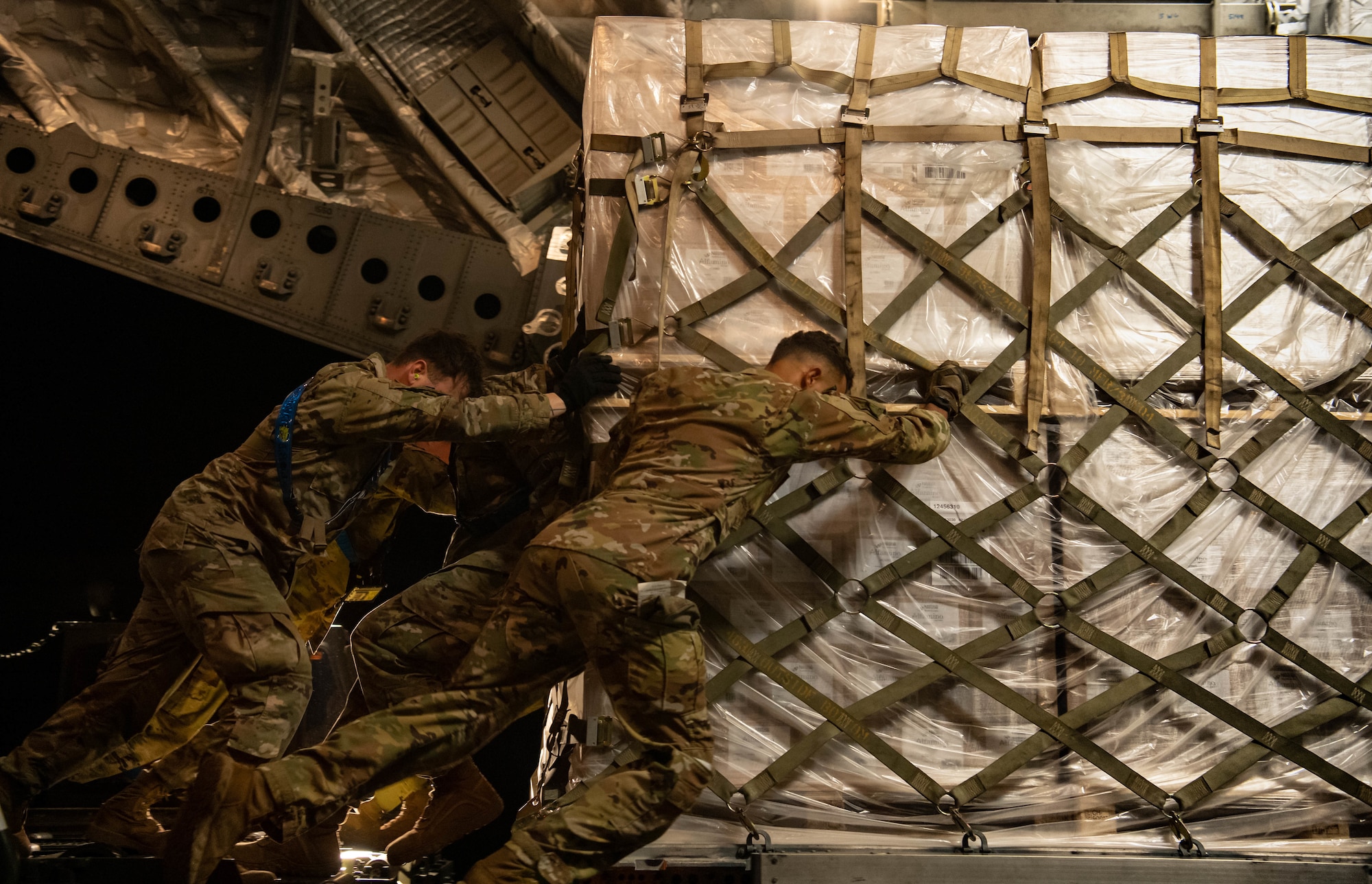 Airmen from the 721st Aerial Port Squadron load a pallet of infant formula onto a C-17 Globemaster lll aircraft assigned to Joint Base Pearl Harbor-Hickam, Hawaii, at Ramstein Air Base, Germany, May 22, 2022. The infant formula arrived from Switzerland as part of the U.S. Government’s Operation Fly Formula to rapidly transport infant formula to the United States due to critical shortages there. Under Operation Fly Formula, the USDA and the Department of Health and Human Services are authorized to request Department of Defense support to pick up overseas infant formula that meets U.S. health and safety standards. (U.S. Air Force photo by Airman 1st Class Jared Lovett)