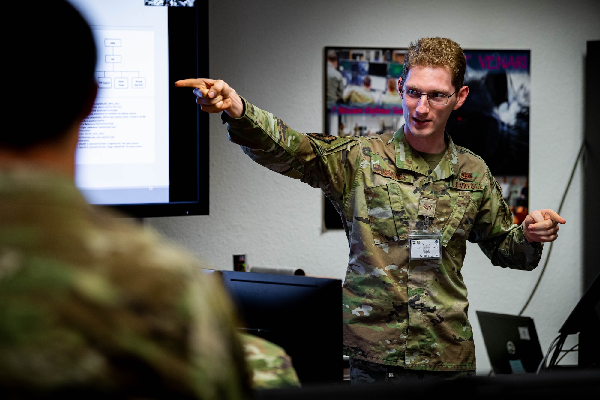 U.S. Air Force Senior Airman Frederic Borries, 52nd Communications Squadron chief of training assigned to Spangdahlem Air Base, Germany, instructs the Mission Defense Team during exercise Tacet Venari at Ramstein Air Base, Germany, May 10, 2022. Tacet Venari is a two-week cyber exercise providing Airmen with four phases of learning, to include education, demonstration, guidance and empowerment.  (U.S. Air Force photo by Airman 1st Class Jared Lovett)