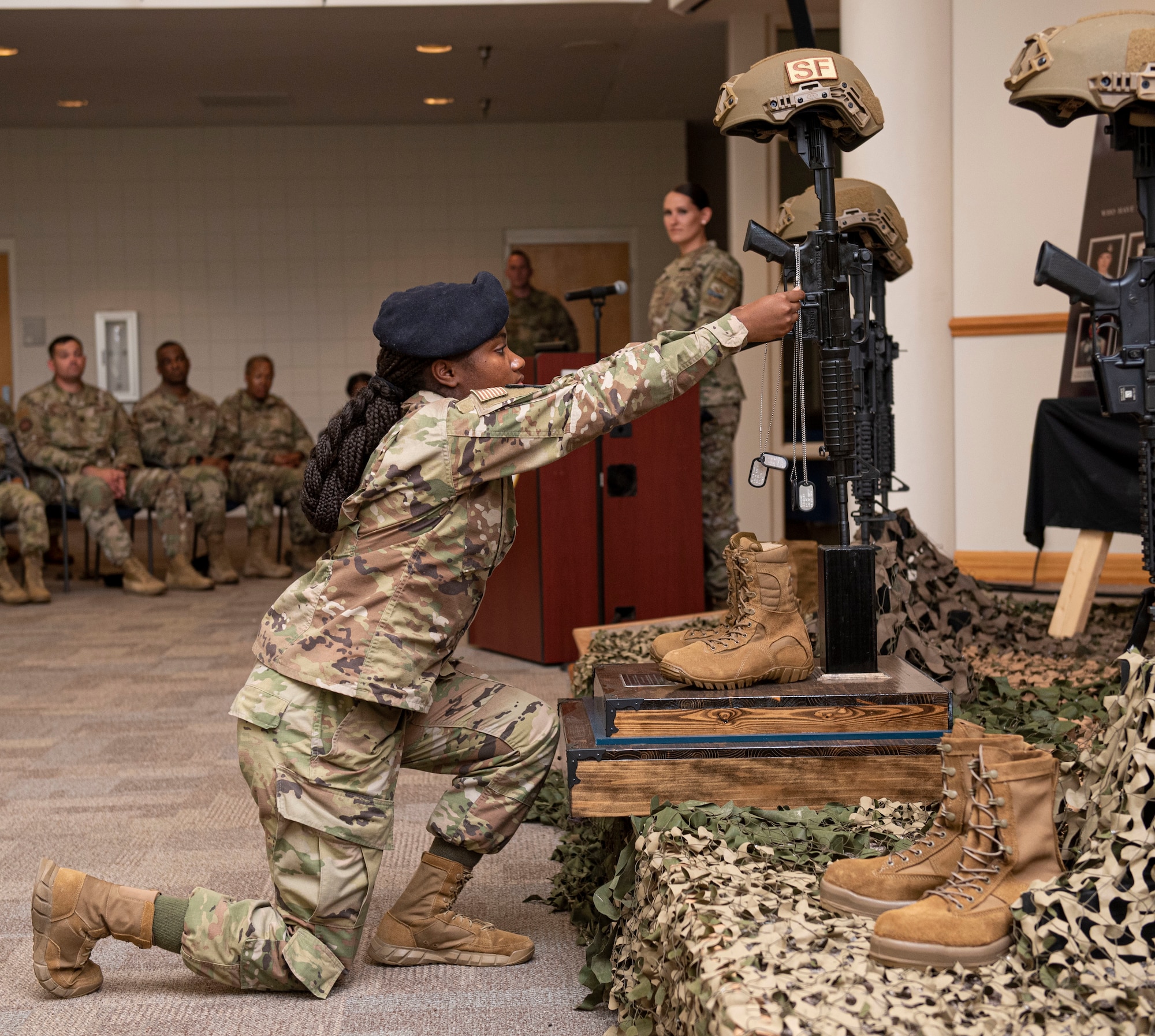 Members assigned to the 4th Security Forces Squadron place the dogtag of a fallen defender on a M-16 rifle during the National Police Week closing ceremony at Seymour Johnson Air Force Base, North Carolina, May 20, 2022. The week's events paid tribute to the fallen men and women of law enforcement.