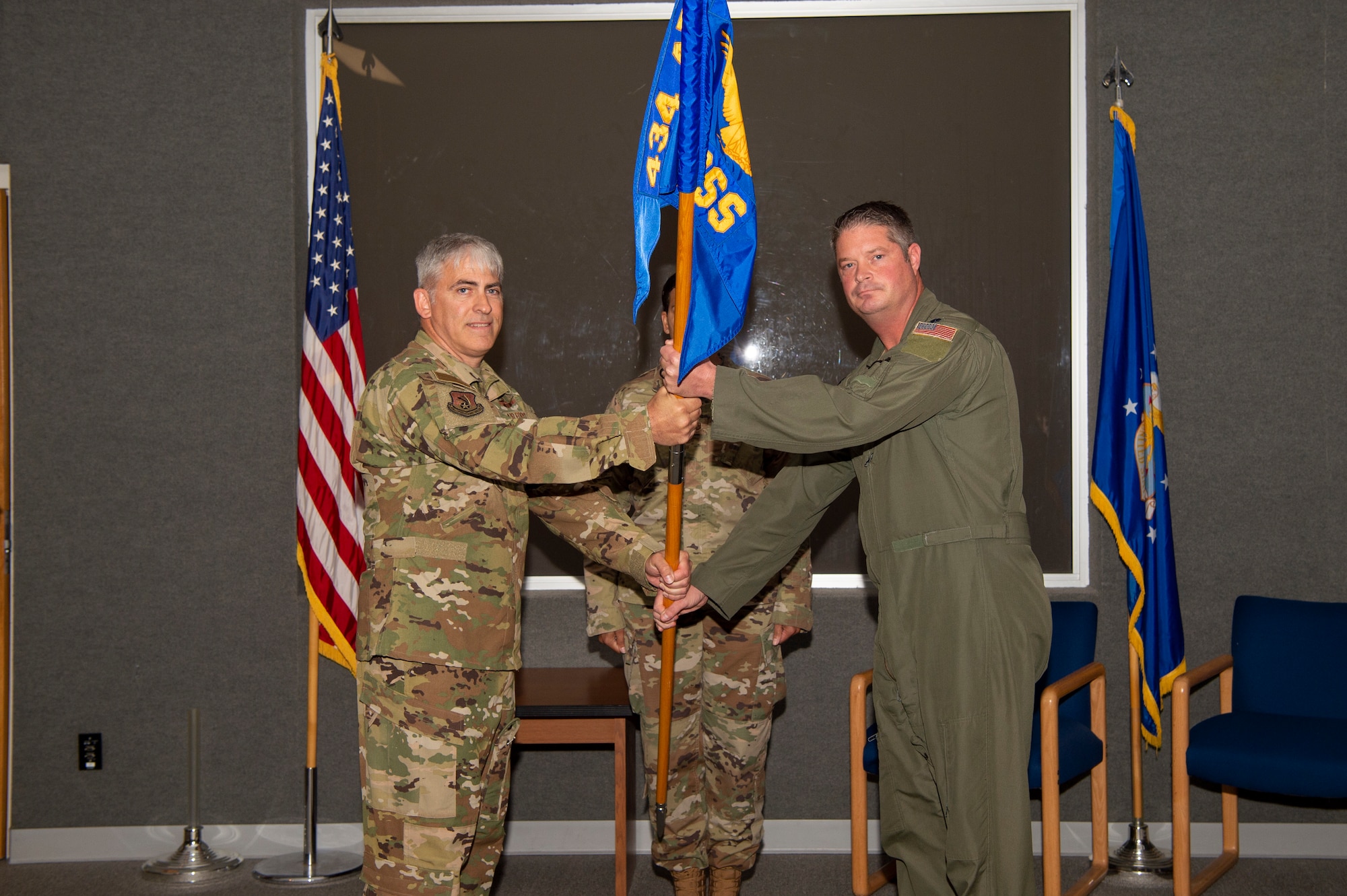 Col. Douglas Perry Jr., 434th Operations Group commander, passes the guidon of the 434th Operations Support Squadron to Lt. Col. David Curl Jr. 434th OSS commander, during an Assumption of Command ceremony at Gus Grissom Hall, Grissom Air Reserve Base, Ind., May 15, 2022. During the ceremony Curl assumed command of the 434th OSS. (U.S. Air Force photo by Staff SGt. Michael Hunsaker)