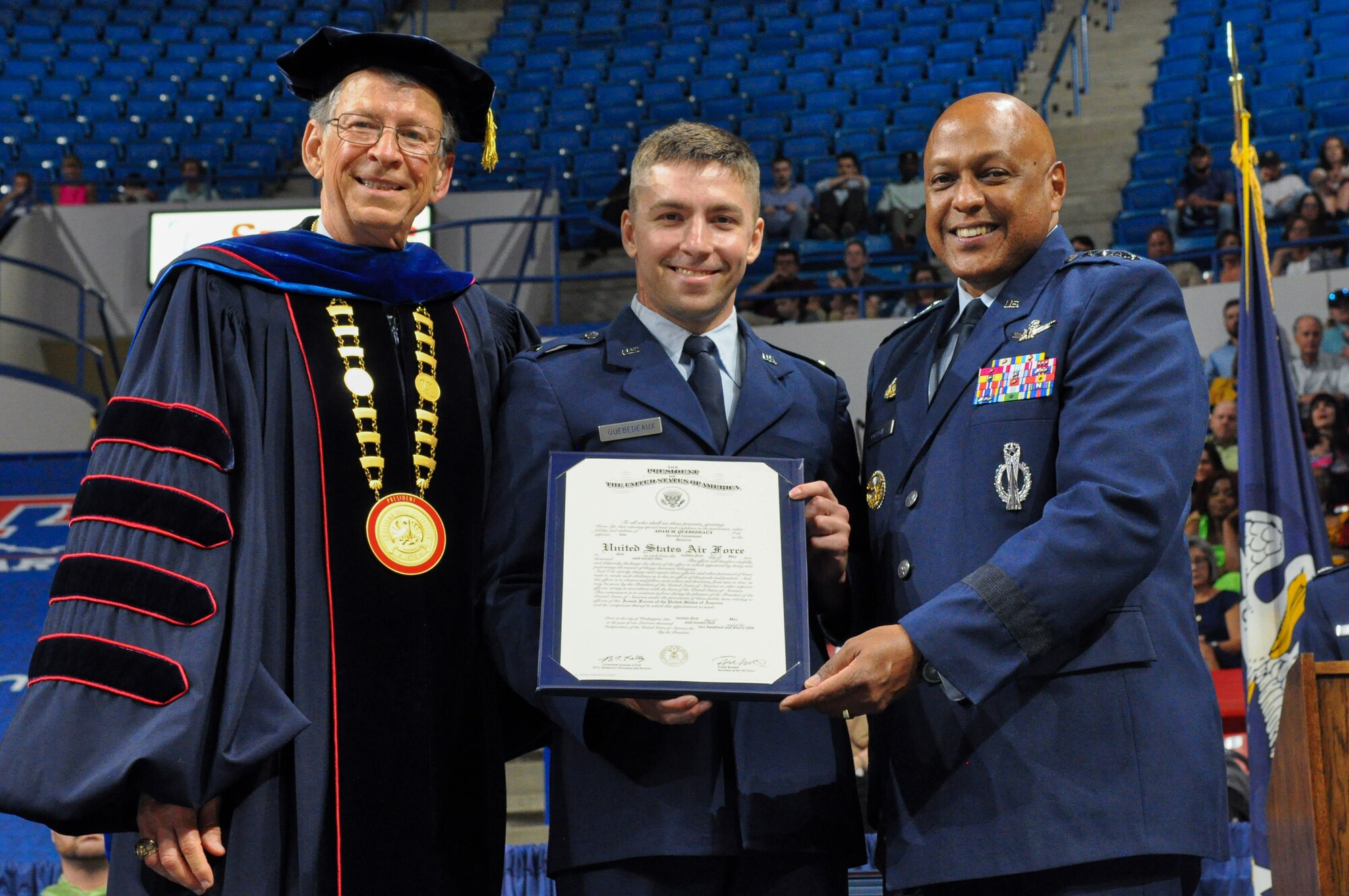 Left, Dr. Les Guice, president of Louisiana Tech University, and right, Gen. Anthony Cotton, commander of Air Force Global Strike Command, stand with a newly commissioned  2nd Lieutenant. Cotton delivered the commencement address to the Louisiana Tech University College of Engineering and Science.