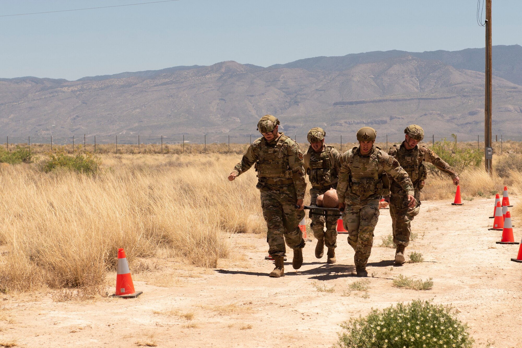 Members of the 49th Security Forces Squadron carry a simulated casualty during a Defender Challenge at the Security Forces Training Complex May 11, 2022, on Holloman Air Force Base, New Mexico. The competition is designed to incorporate scenarios that defenders may have to tackle while on duty.  (U.S. Air Force photo by Airman Isaiah Pedrazzini)