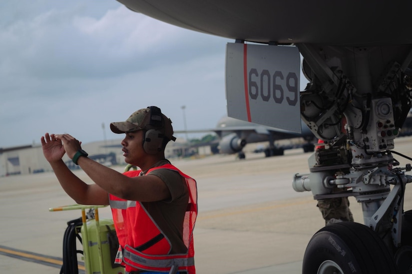 Airman guides set of stairs to KC-46A Pegasus