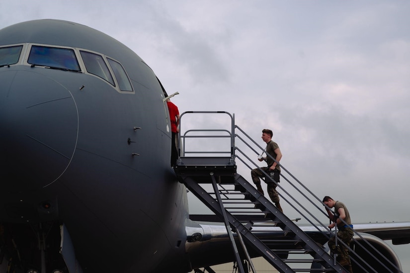 Airman walk up stairs to KC-46A Pegasus