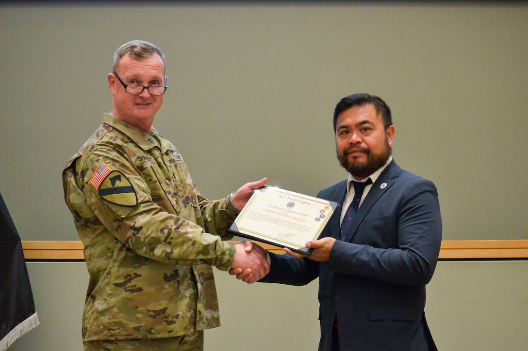 The Defense Logistics Agency Troop Support Commander Army Brig. Gen. Eric Shirley presents a certificate of appreciation to keynote speaker Randy Duque, deputy director of the Philadelphia Commission on Human Relations Community Relations Division, during the annual Asian American, Native Hawaiian and Pacific Islander Month event May 12.