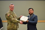 The Defense Logistics Agency Troop Support Commander Army Brig. Gen. Eric Shirley presents a certificate of appreciation to keynote speaker Randy Duque, deputy director of the Philadelphia Commission on Human Relations Community Relations Division, during the annual Asian American, Native Hawaiian and Pacific Islander Month event May 12.