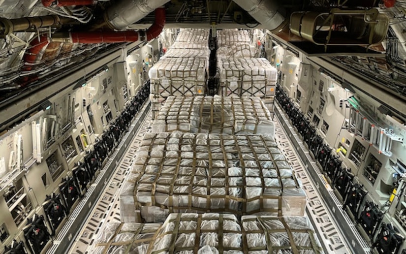 Hundreds of pallets of infant formula in the cargo holding area of an airplane.