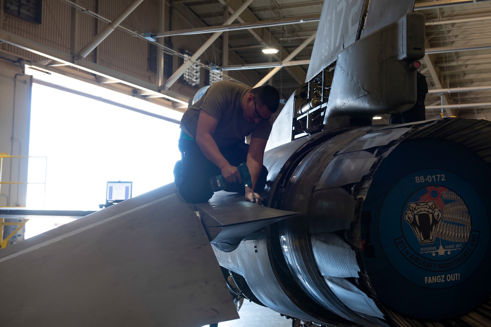 Staff Sgt. Luis Lopez-Rosales, 49th Equipment Maintenance Squadron aircraft phase inspection section journeyman, installs a panel on an F-16 Viper, May 18, 2022, on Holloman Air Force Base, New Mexico.