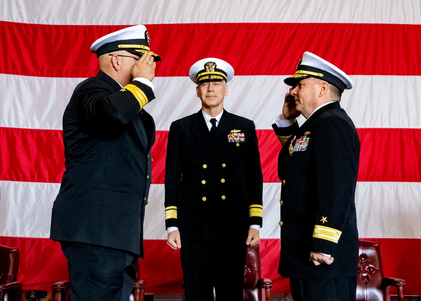 NORFOLK, Va. (April 6, 2022) Rear Adm. Dennis Velez, left, relieves Rear Adm. Rick Cheeseman, as Commander, Carrier Strike Group (CSG) 10, as Rear Adm. Fred Pyle, director, Maritime Operations, U.S. Fleet Forces Command, presides during a change of command ceremony aboard the aircraft carrier USS George H.W. Bush (CVN 77) April 6, 2022. CSG-10 is an integrated combat weapons system that delivers superior combat capability to deter, and if necessary, defeat America’s adversaries in support of national security. It achieves its mission by projecting the combined power of George H.W. Bush, Carrier Air Wing 7, Destroyer Squadron 26, and the Ticonderoga-class guided-missile cruiser USS Leyte Gulf (CG 55). (U.S. Navy photo by Mass Communication Specialist 3rd Class Bryan Valek)