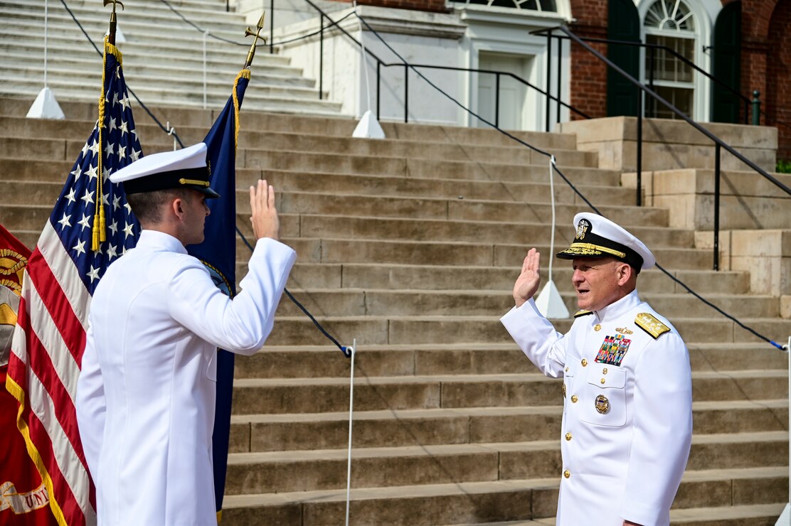 CHARLOTTESVILLE, Va. (May 20, 2022) ​​Chief of Naval Operations Adm. Mike Gilday gives the oath of office to Ensign Brian Gilday during a commissioning ceremony at the University of Virginia. (U.S. Navy photo by Mass Communication Specialist 1st Class Sean Castellano/Released)