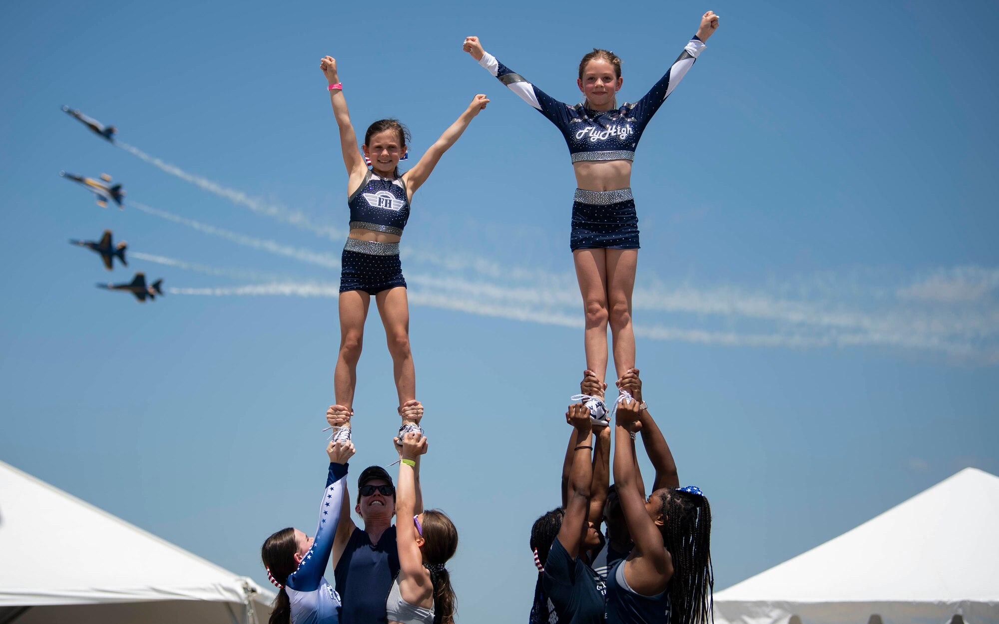 Gymnasts from Fly High gym perform during the 2022 Thunder Over Dover Airshow, May 22, 2022, at Dover Air Force Base, Delaware. The show featured more than 20 different military and civilian aircraft static displays as well as performances from local community members. (U.S. Air Force photo by Tech. Sgt. J.D. Strong II)