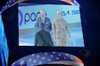 Wayne Messmer, left, Senior Executive Vice President, Chicago Wolves, and Sgt. 1st Class Moises Garcia appear on the Jumbotron before the singing of the National Anthem during a Chicago Wolves military appreciation game, May 21, 2022, at the All-State Arena.