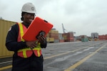 Coast Guard Petty Officer 3rd Class Breanna Kinchen-Wood, a marine science technician at Coast Guard Sector Maryland-National Capital Region, documents the findings of hazardous materials inspections, at the Port of Baltimore, Baltimore, Maryland, Sept. 18, 2018. The Coast Guard inspects cargoes and containers for undeclared hazardous materials and to ensure compliance with laws and regulations on shipping hazardous materials. (U.S. Coast Guard photo by Petty Officer 2nd Class Lisa Ferdinando)