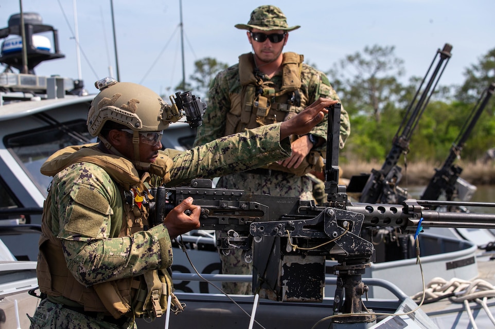 U.S. Navy Engineman David Thompson, assigned to Maritime Expeditionary Security Squadron 4, conducts a systems check on a M2A1 machine gun during static and dynamic maritime force protection procedures at Marine Corps Air Station Cherry Point Navy Boat Docks, North Carolina, May 5, 2022. The exercise was intended to increase the sailors’ ability to gauge maneuvers of small enemy boats and their understanding of the enemy’s thought process. The mission of the Navy Boat Docks is to provide support to the air station, its bombing targets, and offer a training environment for Navy and Marine Corps units. (U.S. Marine Corps photo by Lance Cpl Symira Bostic)