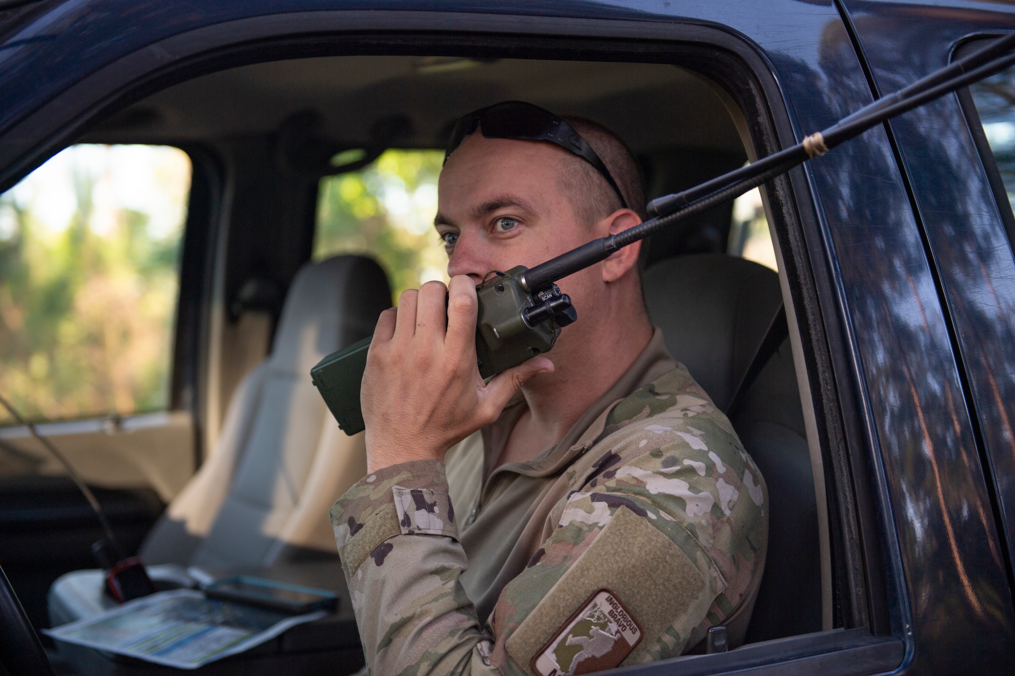 Photo of an Airman talking on a radio.