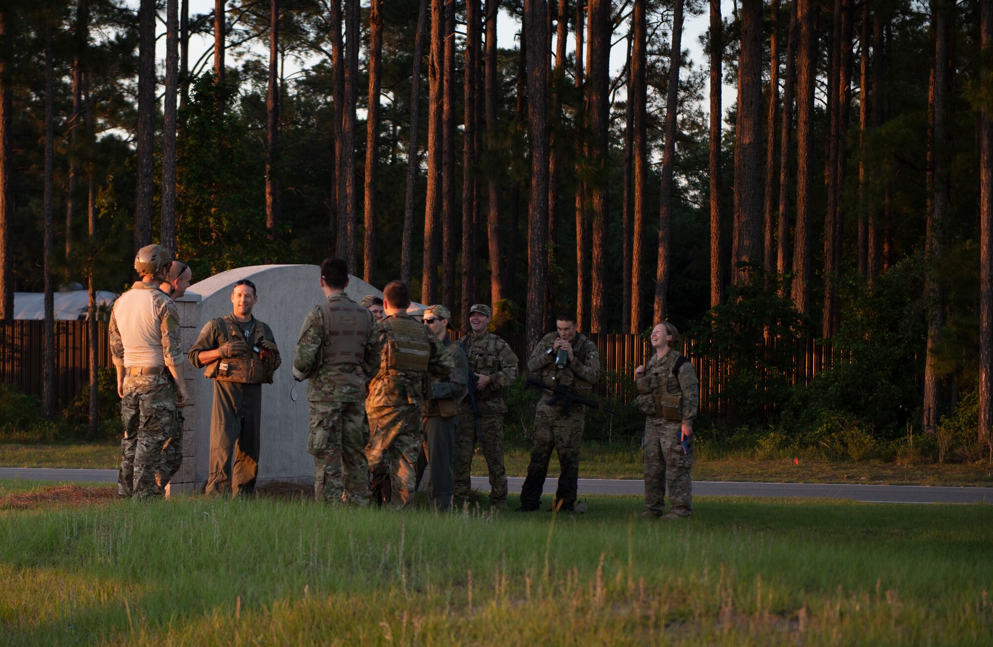 Photo of Airmen talking as a group at the end of their field training.