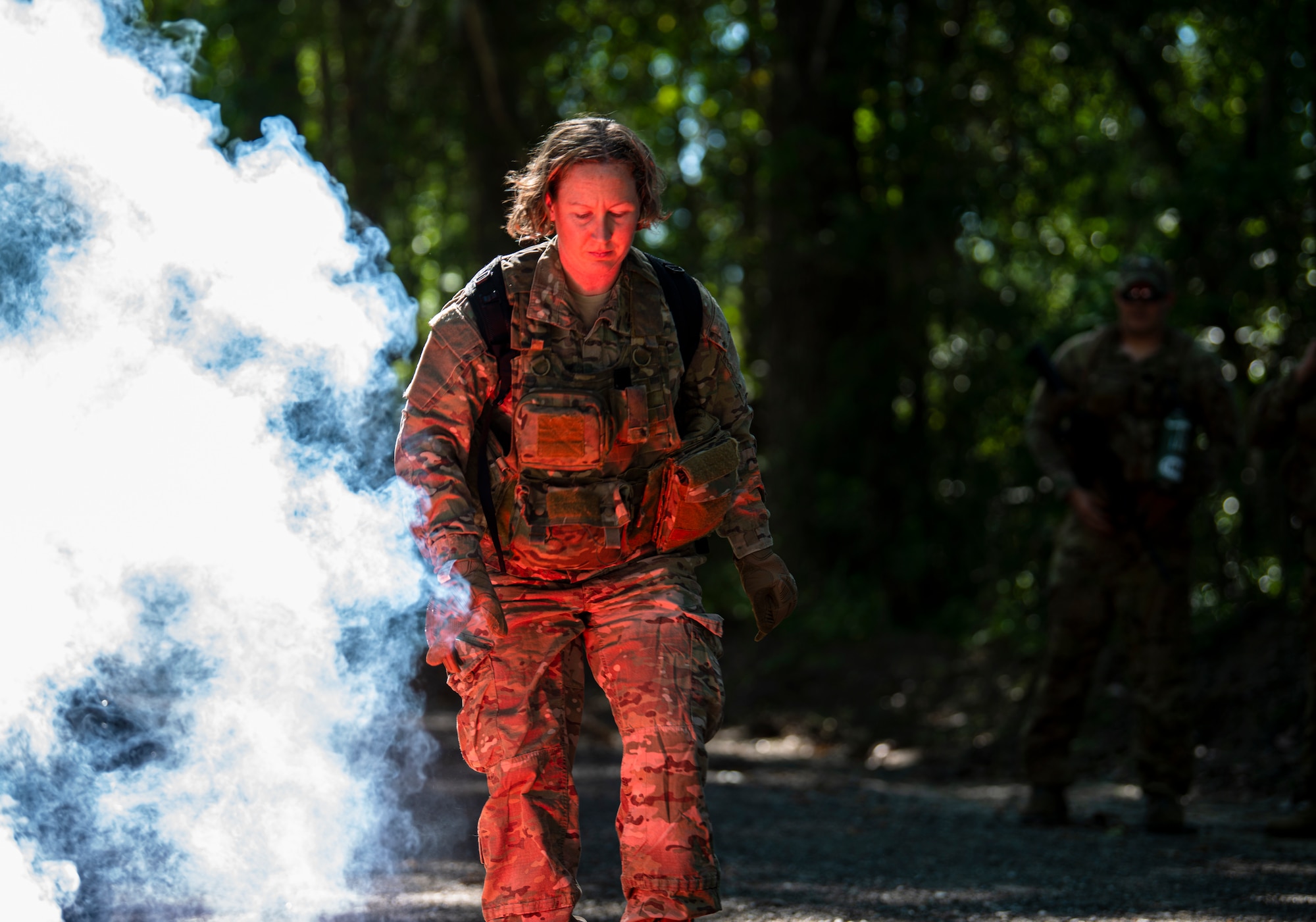 Photo of an Airman igniting a smoke flare.