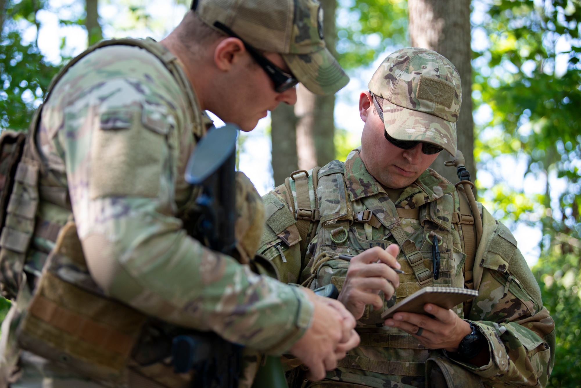 Photo of two Airmen looking over information before beginning field training.