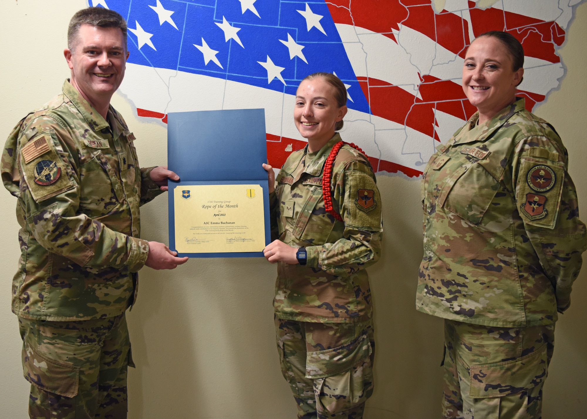 U.S. Air Force Lt. Col. James Freeman, 17th Training Group deputy commander, presents the 17th TRG Rope of the Month award to Airman 1st Class Emma Buchanan, 315th Training Squadron student, Goodfellow Air Force Base, Texas, May 20, 2022. Red ropes are responsible for overseeing other ropes and students within their squadron. (U.S. Air Force photo by Senior Airman Ethan Sherwood)