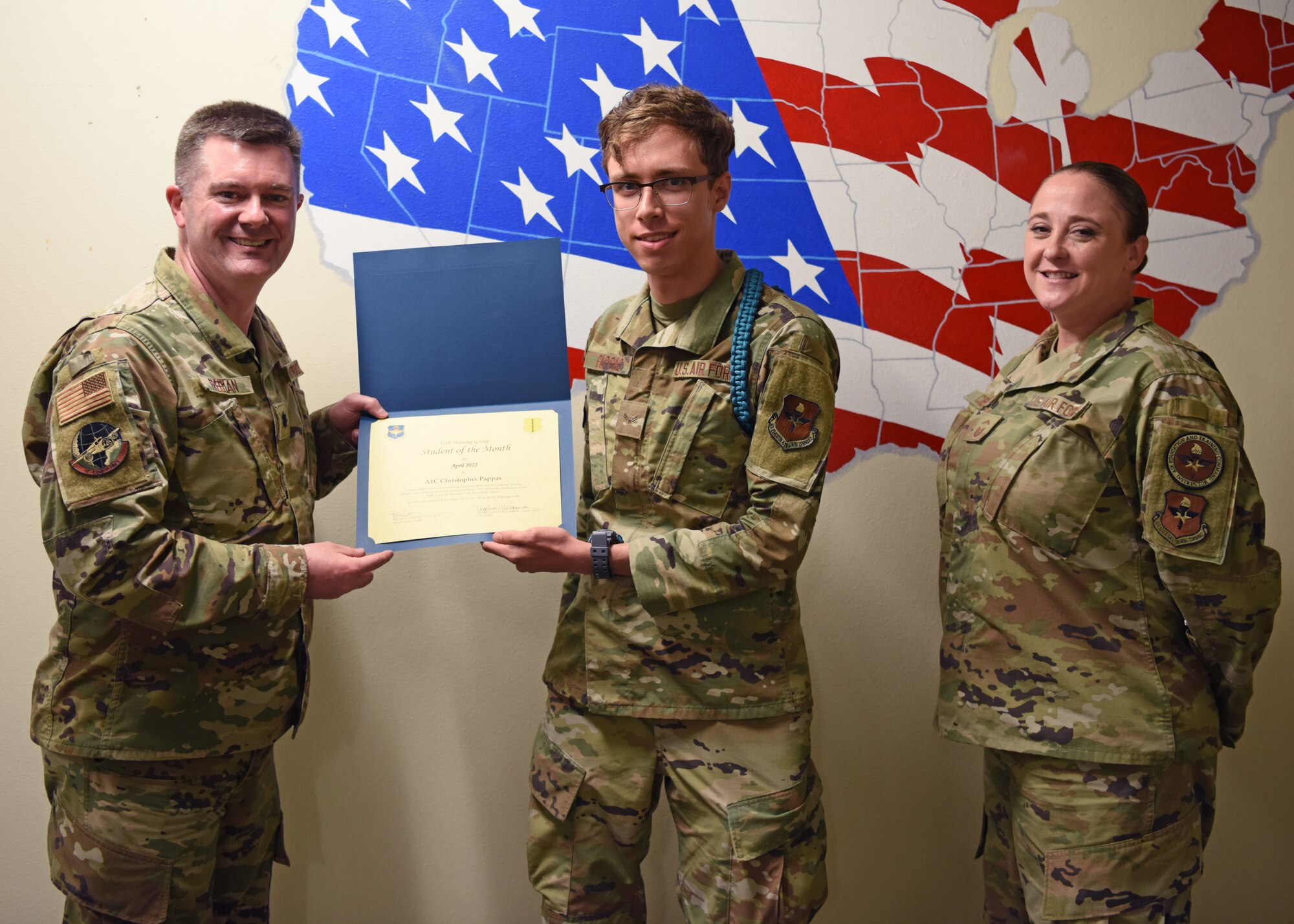 U.S. Air Force Lt. Col. James Freeman, 17th Training Group deputy commander, presents the 316th Training Squadron Student of the Month award to Airman 1st Class Christopher Pappas, 316th TRS student, Goodfellow Air Force Base, Texas, May 20, 2022. Pappas worked hard for their award and has shown dedication to the squadron and their training at Goodfellow. (U.S. Air Force photo by Senior Airman Ethan Sherwood)