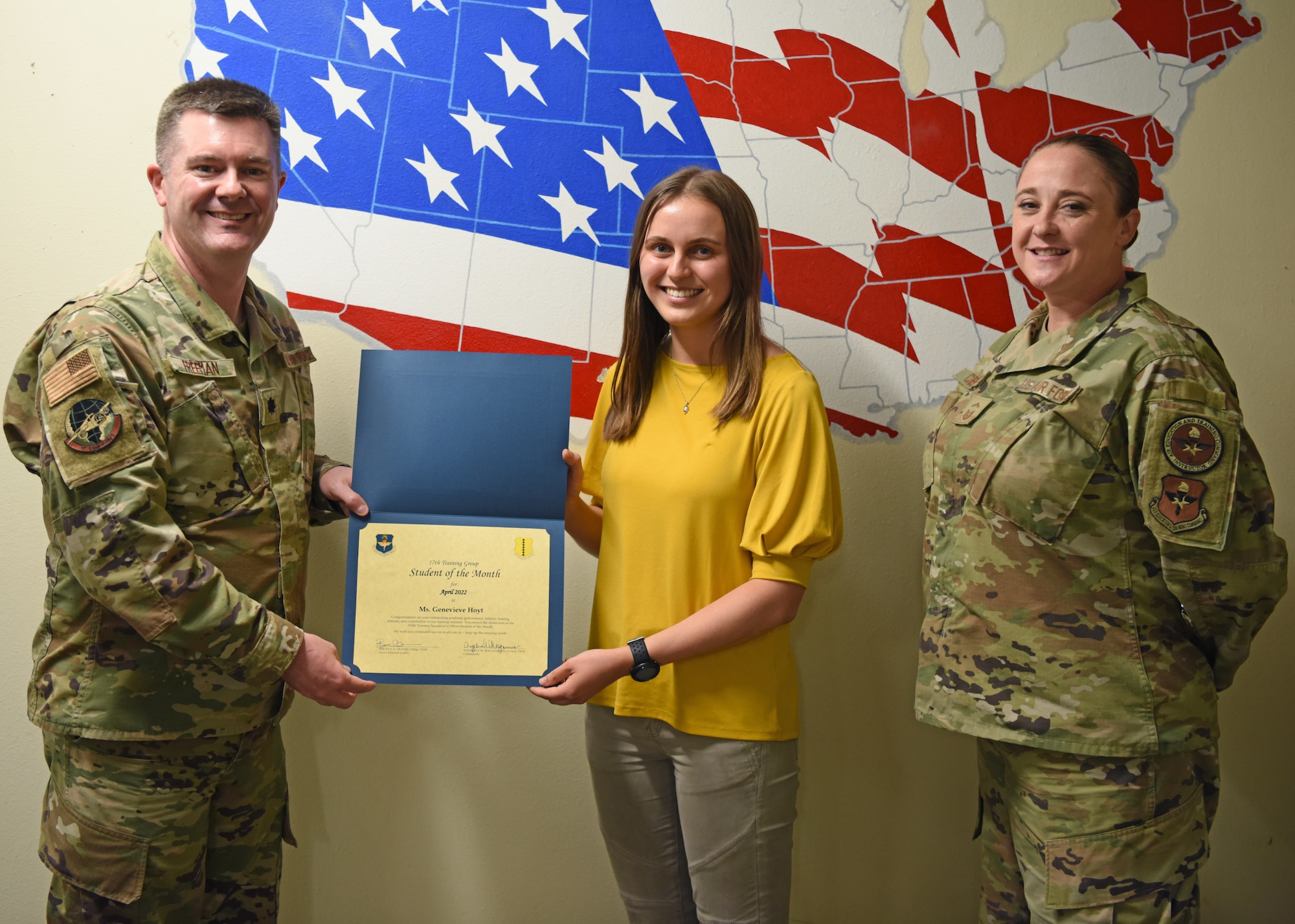 U.S. Air Force Lt. Col. James Freeman, 17th Training Group deputy commander, presents the 315th Training Squadron Officer Student of the Month award to Genevieve Hoyt, 315th TRS student, Goodfellow Air Force Base, Texas, May 20, 2022. Hoyt worked hard for her award and has shown her dedication to her squadron and the training she received at Goodfellow. (U.S. Air Force photo by Senior Airman Ethan Sherwood)