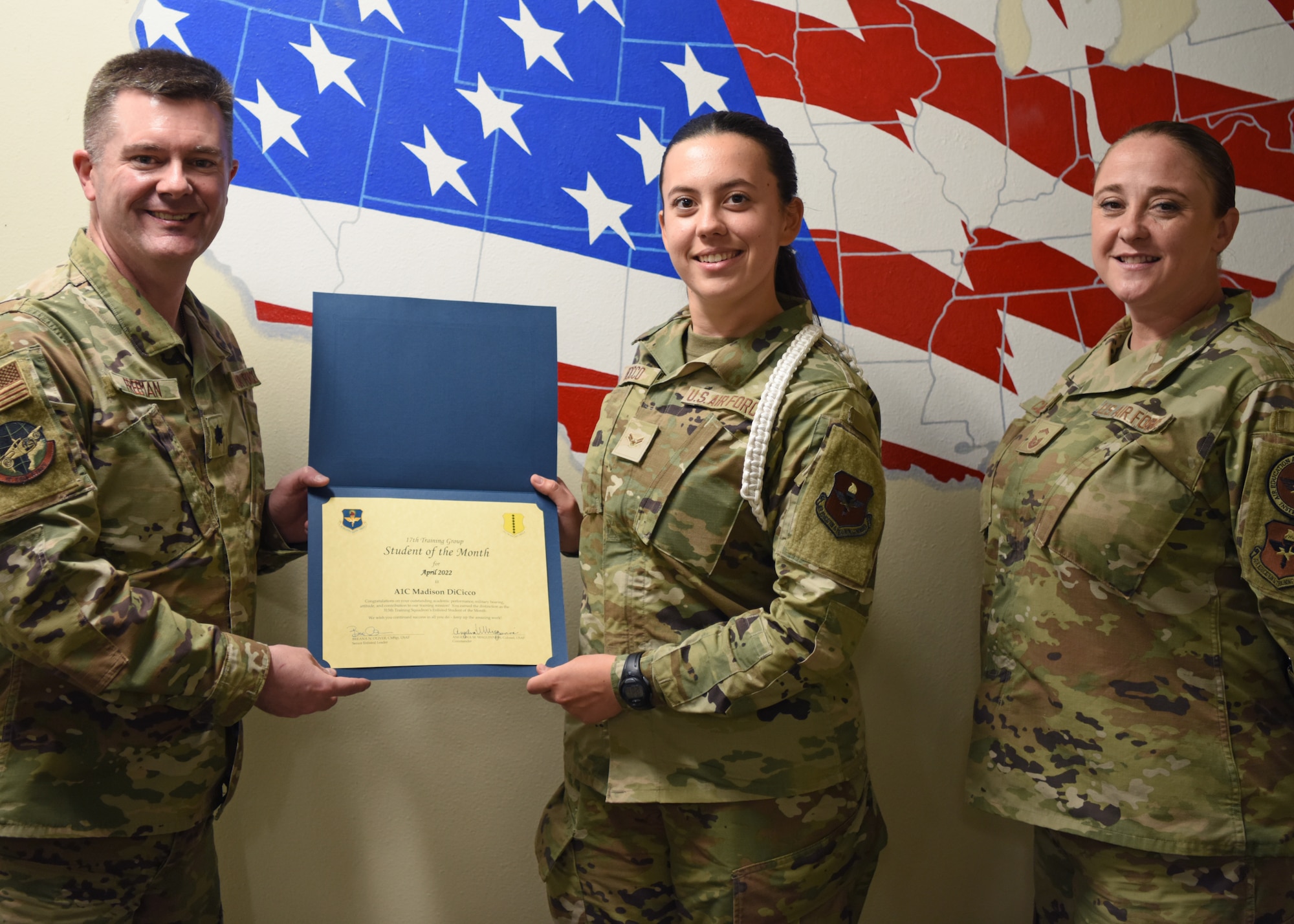 U.S. Air Force Lt. Col. James Freeman, 17th Training Group deputy commander, presents the 315th Training Squadron Enlisted Student of the Month award to Airman 1st Class Madison DiCicco, 315th TRS student, Goodfellow Air Force Base, Texas, May 20, 2022. DiCicco worked hard for her award and has shown her dedication to her squadron and the training she received at Goodfellow. (U.S. Air Force photo by Senior Airman Ethan Sherwood)