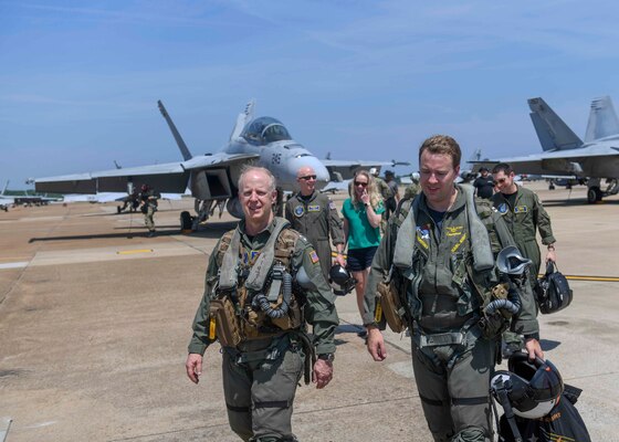 VIRGINIA BEACH, Va. (May 21, 2022) - Commander, U.S. Fleet Forces Command Adm. Daryl Caudle, left, and Lt. Karl “Kramps” Knight, an instructor pilot for Strike Fighter Squadron (VFA) 106, walk off the flight line on Naval Air Station Oceana after taking a flight in an F/A-18 Super Hornet aircraft.