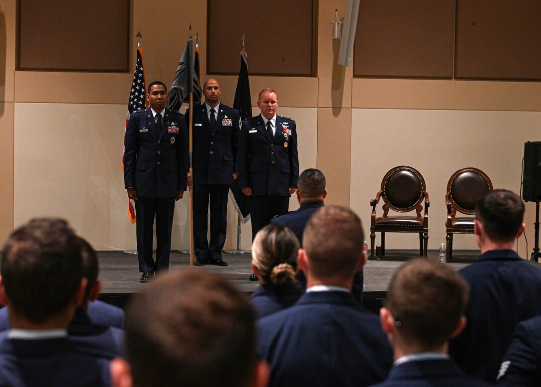 Col. Marcus Jackson, Space Base Delta 2 commander, Chief Master Sgt. Robert Devall, SBD 2 command chief, and Col. Brian Chellgren, SBD 2 vice commander, stand before a formation after successfully completing a combined unit inactivation and redesignation ceremony on Buckley Space Force Base, Colo., May 23, 2022.