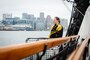 Cmdr. B.J. Farrell, commanding officer of USS Constitution, watches the city of Boston during an underway aboard Constitution.