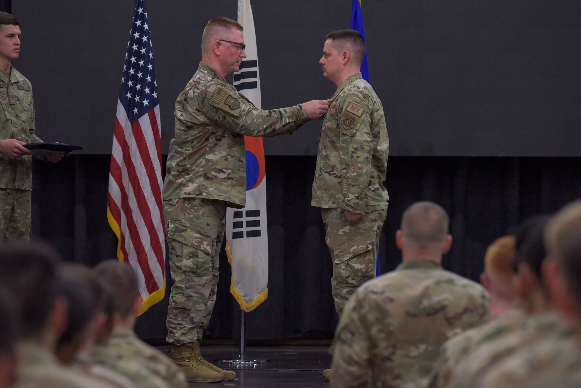 Col. Brian Moore, left, 51st Maintenance Group commander, presents a Meritorious Service Medal to Maj. Benjamin Abshire, 51st Maintenance Squadron outgoing commander, during the 51st MXS of command ceremony at Osan Air Base, Republic of Korea, May 23, 2022.