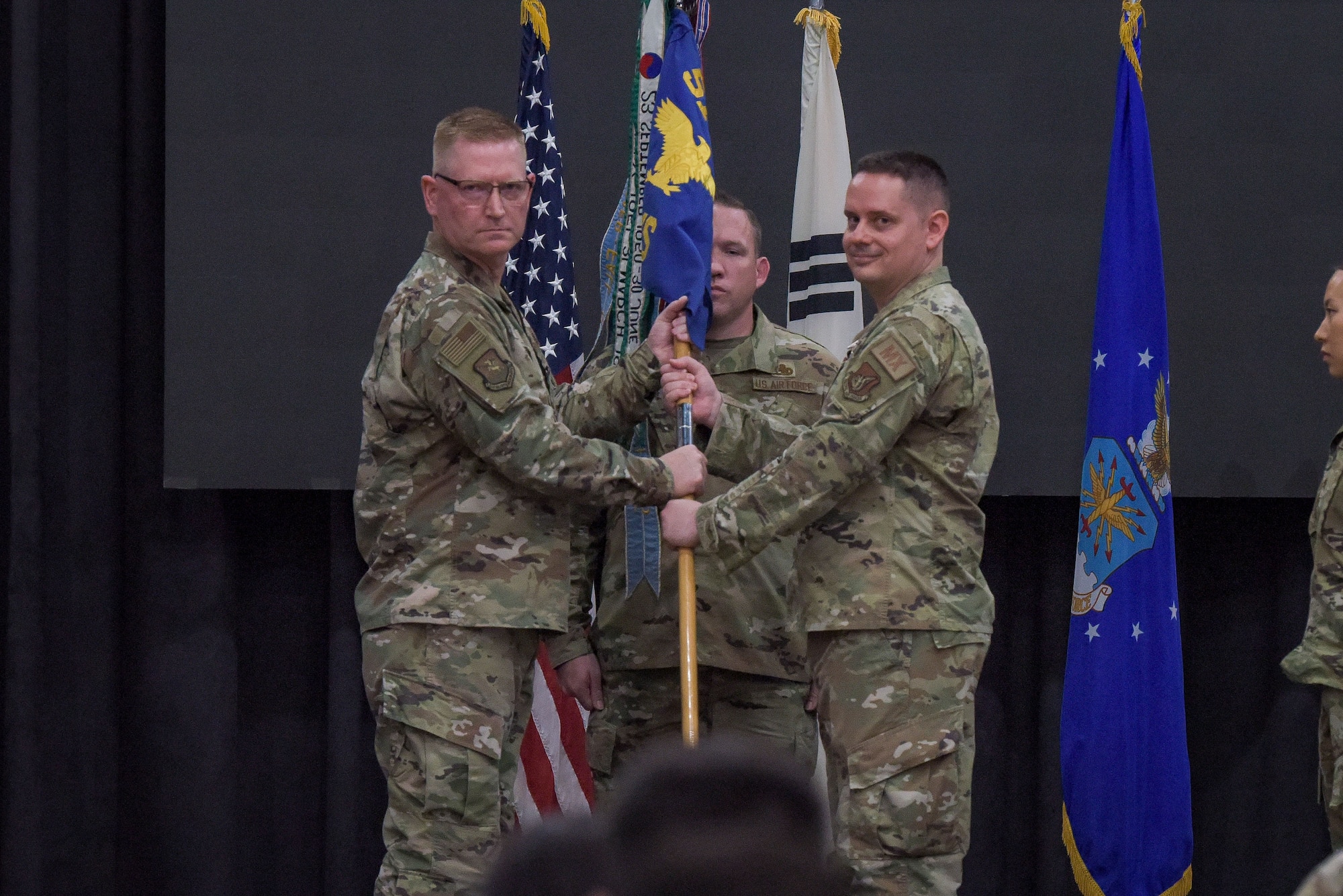 Maj. Benjamin Abshire, 51st Maintenance Squadron outgoing commander, relinquishes command during 51st MXS change of command ceremony at Osan Air Base, Republic of Korea, May 23, 2022.