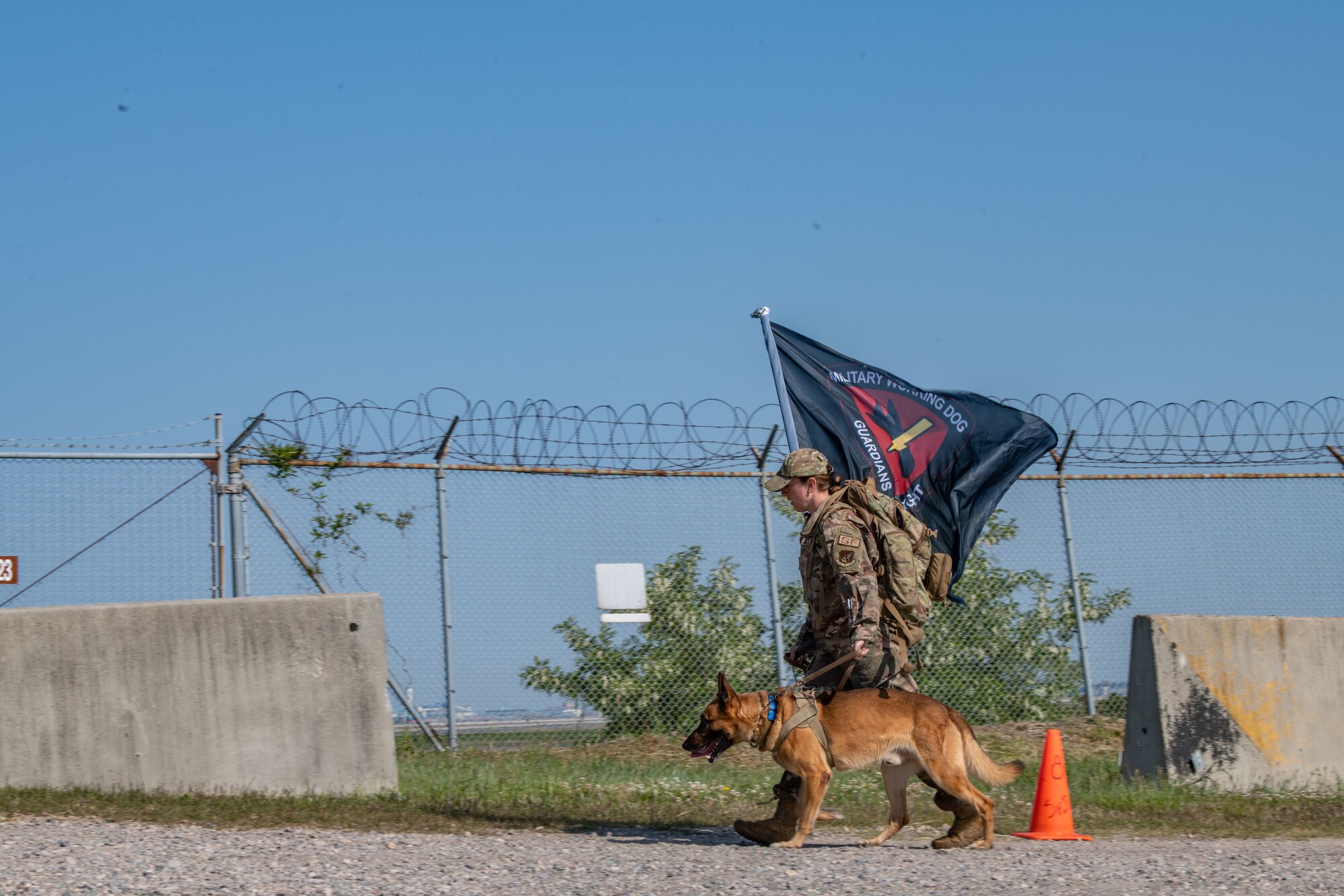 Staff Sgt. Darby Misner, 8th Security Forces Military Working Dog Handler, rucks with MWD Bonus, in a memorial ruck during Police Week 2022 at Kunsan Air Base, Republic of Korea, May 16, 2022. The six-mile memorial ruck march was dedicated to the security forces Airmen who have lost their lives in combat since 2001. (U.S. Air Force photo by Staff Sgt. Jesenia Landaverde)