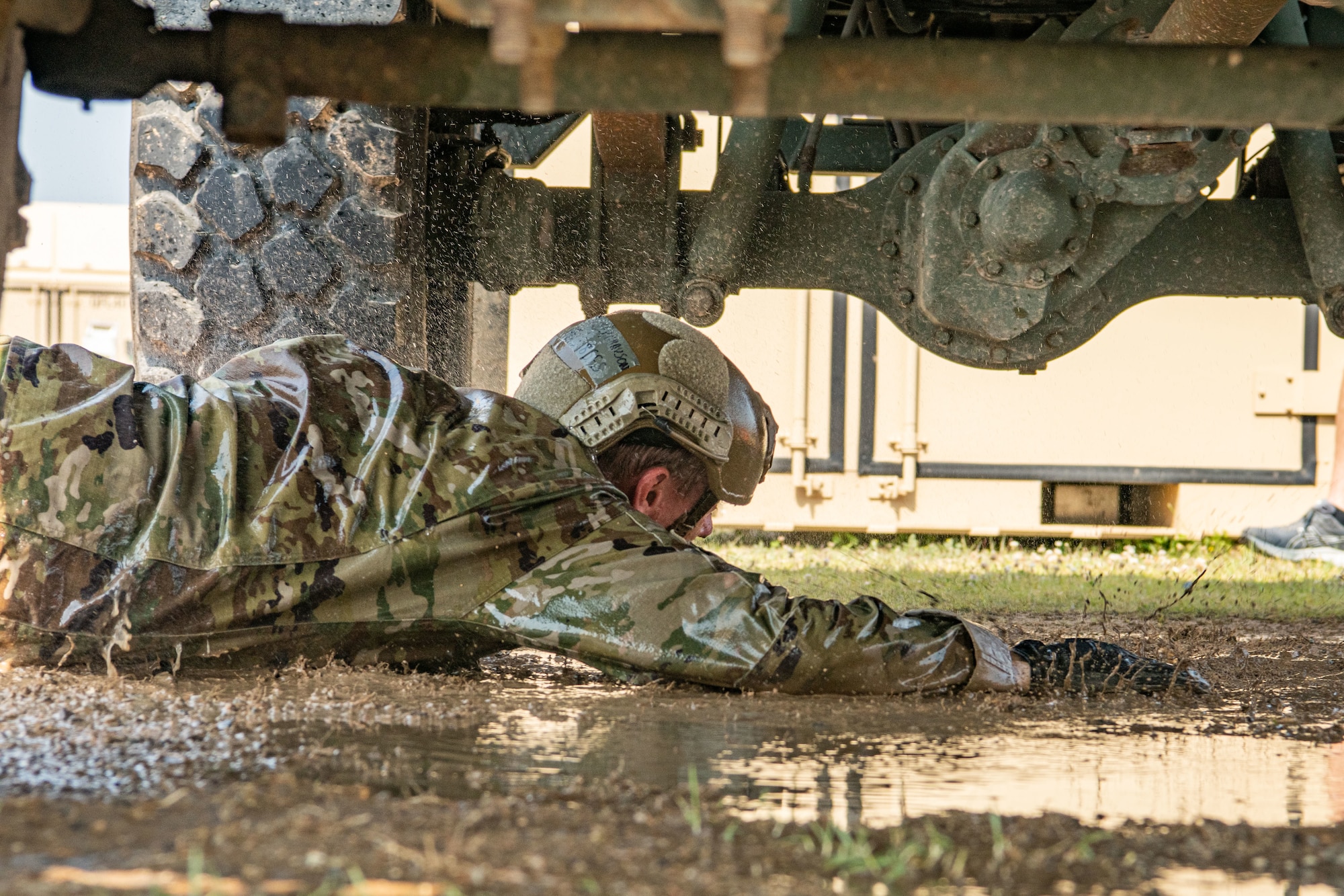 Airman 1st Class Grayson Stanley, 8th Security Forces Squadron defender, performs a low crawl in the Defender Challenge during Police Week 2022 at Kunsan Air Base, Republic of Korea, May 17, 2022. The Defender Challenge was designed to be a test of physical strength, memory, as well as individual and teamwork skills. (U.S. Air Force photo by Staff Sgt. Jesenia Landaverde)