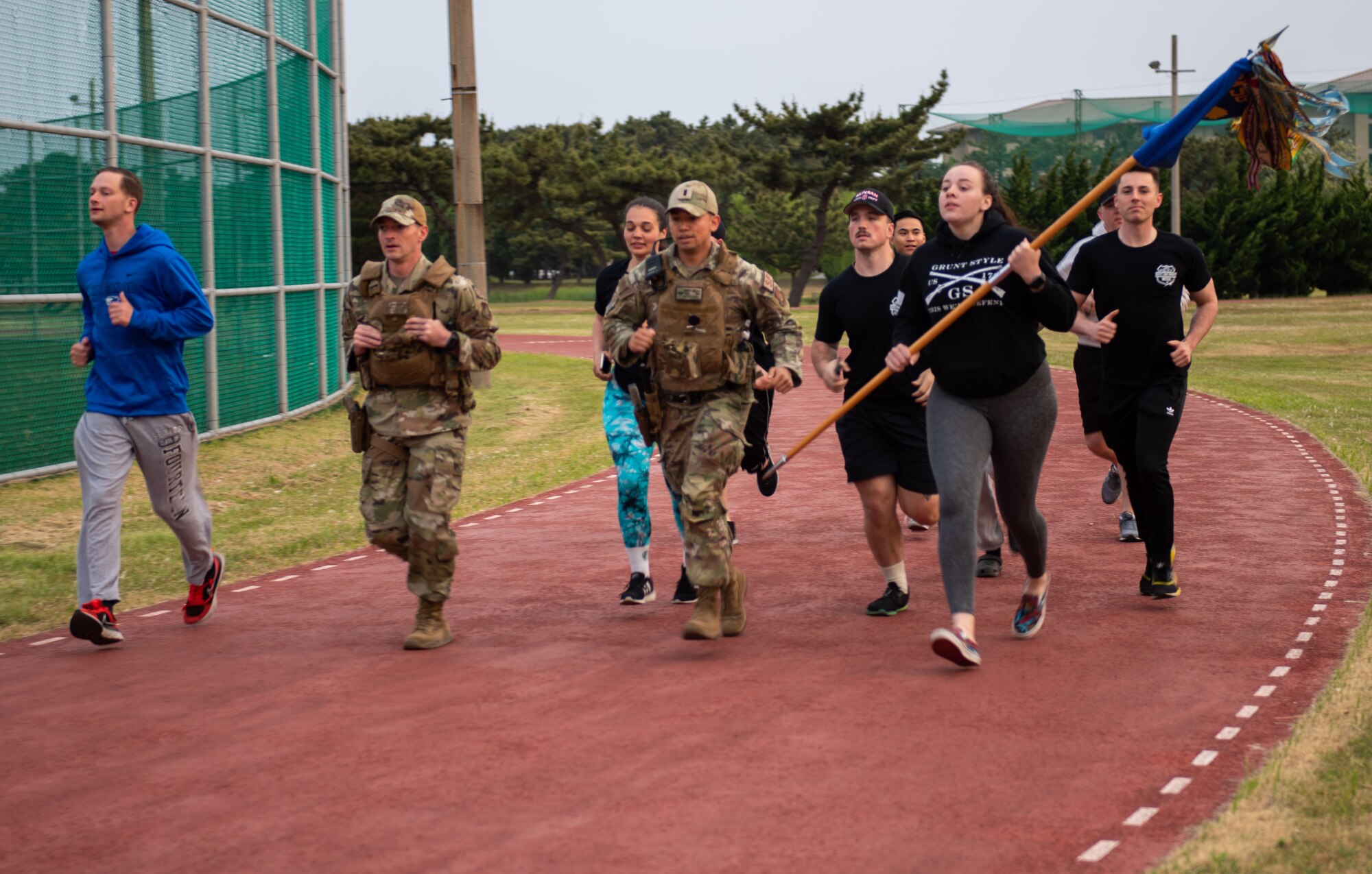 Members of the 8th Security Forces Squadron hustle to the finish of the 24/7 memorial run/walk on Kunsan Air Base, Republic of Korea, May 19, 2022. National Police Week pays special recognition to law enforcement officers who have lost their lives in the line of duty for the safety and protection of others. (U.S. Air Force Photo by Tech Sgt. Timothy Dischinat)
