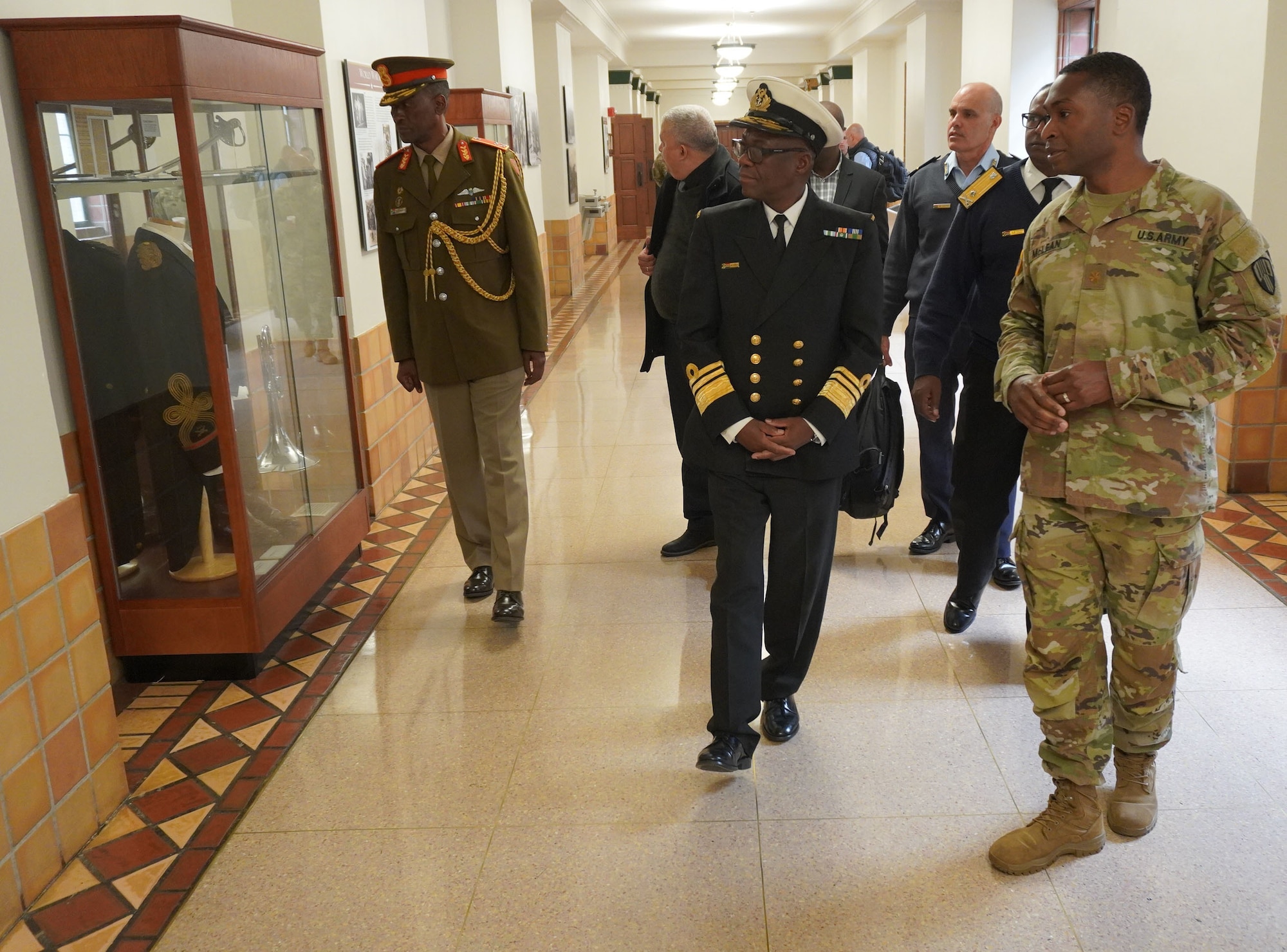 New York Army National Guard Maj. Anthony McLean, the executive officer of the 369th Sustainment Brigade, conducts a tour of the brigade’s historic Harlem Armory for a delegation of South African officers and academics April 21, 2022. The South Africans met with officials at the U.S. Military Academy at West Point to sign an agreement setting up an exchange program with South Africa’s officer education program.