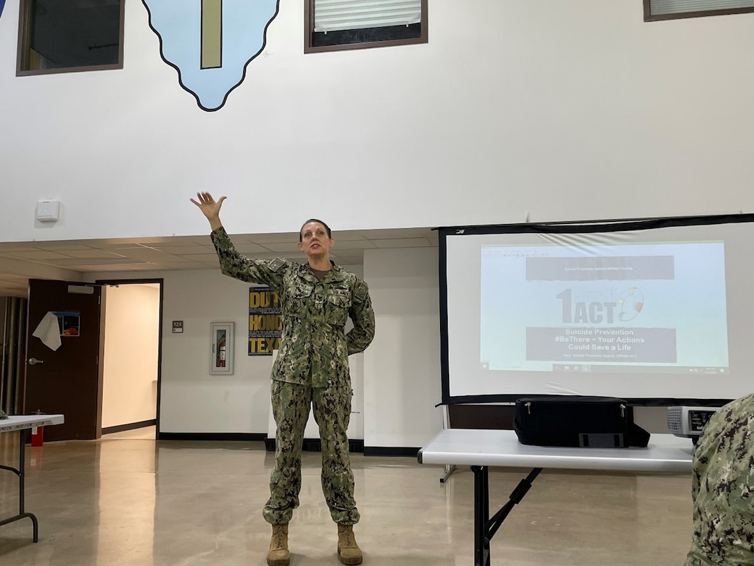 Personnel Specialist 1st Class Kitara Byerly gestures to the empty space where her husband, U.S. Army Specialist John Meyer would have stood. Hospital Corpsman 1st Class Travis Morton led the suicide prevention training with Byerly assisting at Reserve Center Austin, Texas, July 11. (Courtesy Photo)