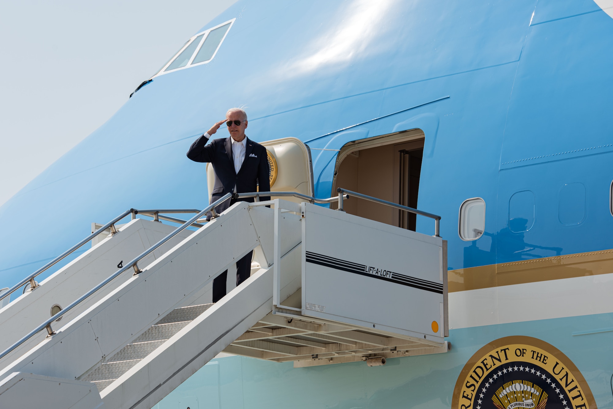 US President Joe Biden renders a salute to United States Forces Korea members before boarding Air Force One