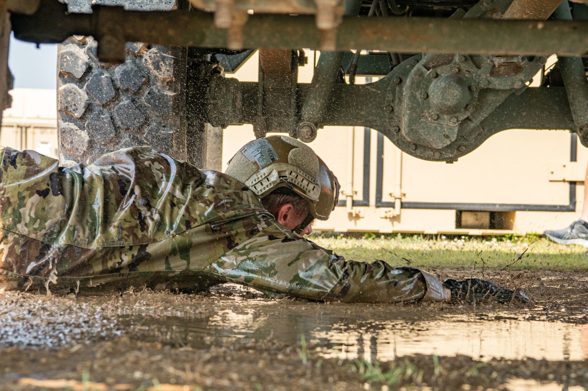 Airman 1st Class Grayson Stanley, 8th Security Forces Squadron defender, performs a low crawl in the Defender Challenge during Police Week 2022 at Kunsan Air Base, Republic of Korea, May 17, 2022. The Defender Challenge was designed to be a test of physical strength, memory, as well as individual and teamwork skills. (U.S. Air Force photo by Staff Sgt. Jesenia Landaverde)