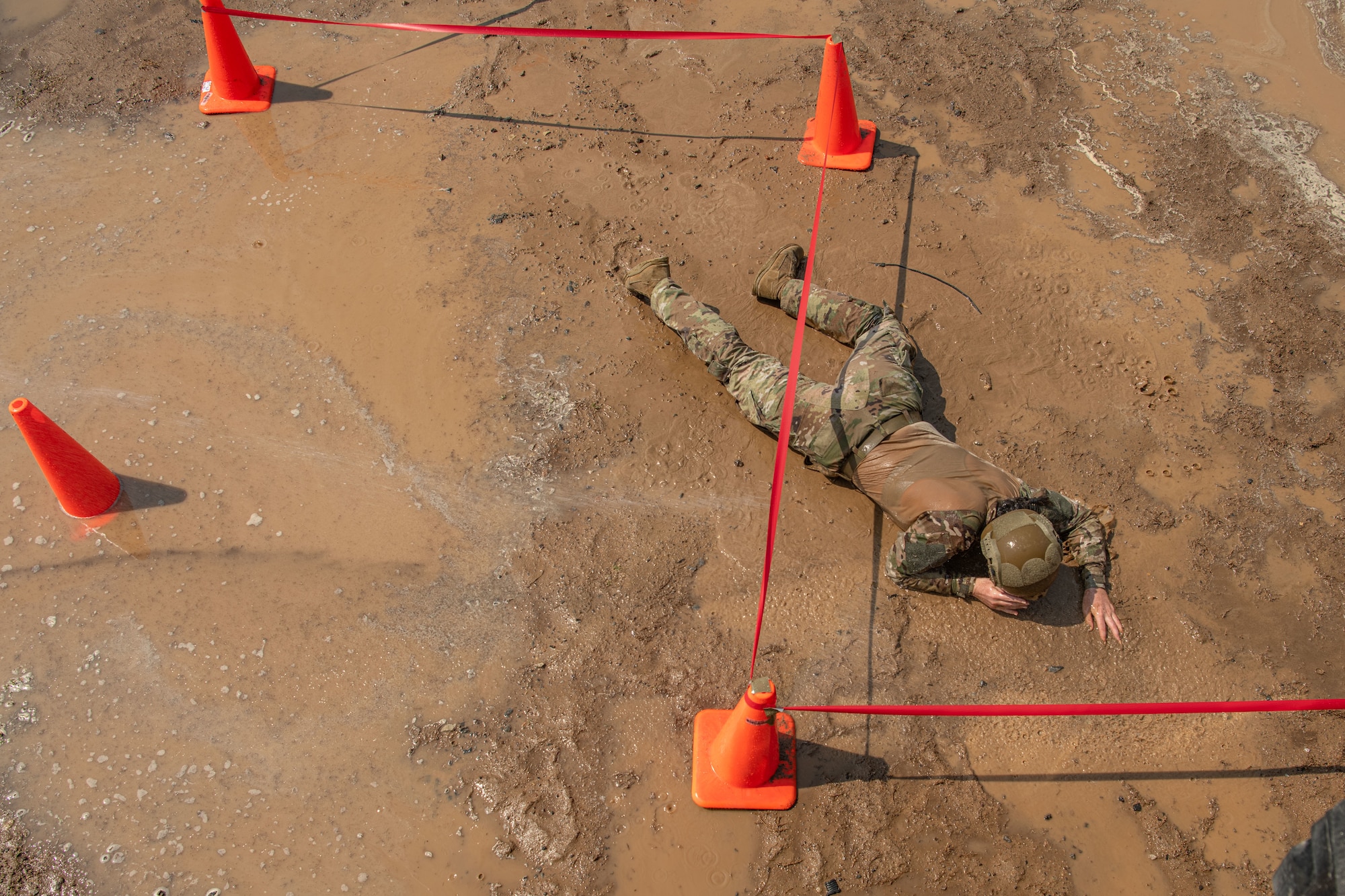Airman 1st Class Bethany Peoples, 8th Security Forces Squadron defender, performs a low crawl in the Defender Challenge during Police Week 2022 at Kunsan Air Base, Republic of Korea, May 17, 2022. National Police Week pays special recognition to law enforcement officers who have lost their lives in the line of duty for the safety and protection of others. (U.S. Air Force photo by Staff Sgt. Jesenia Landaverde)
