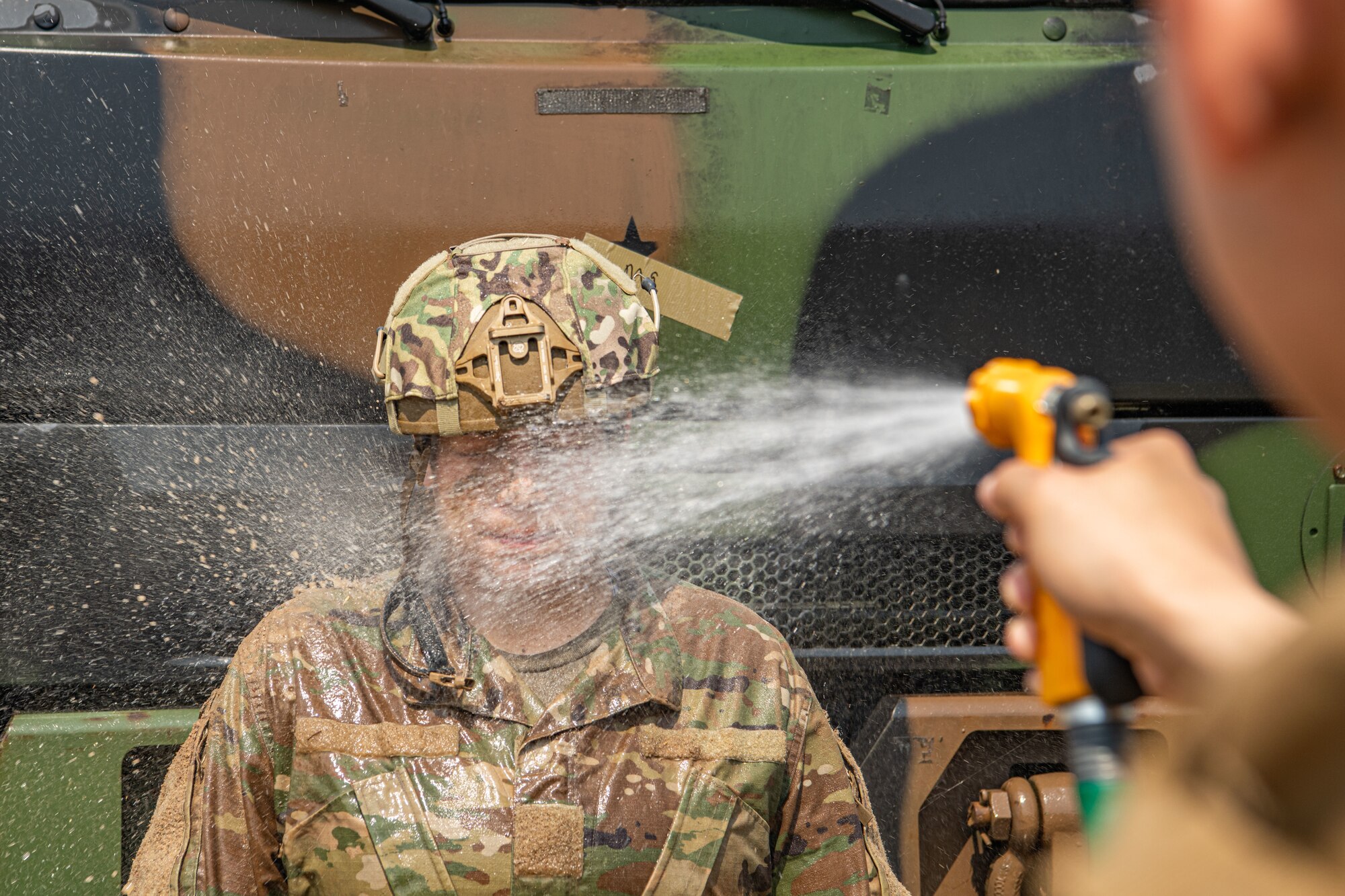 Staff Sgt. Laura Maciel Arciga, 8th Security Forces Squadron Investigation Section investigator, gets cleaned up after competing in the Defender Challenge during Police Week 2022 at Kunsan Air Base, Republic of Korea, May 17, 2022. During this week, Airmen from the 8th Fighter Wing participated in a myriad of activities to pay tribute to fallen law enforcement officers; to include a memorial run, rifle competition and relay challenge. (U.S. Air Force photo by Staff Sgt. Jesenia Landaverde)