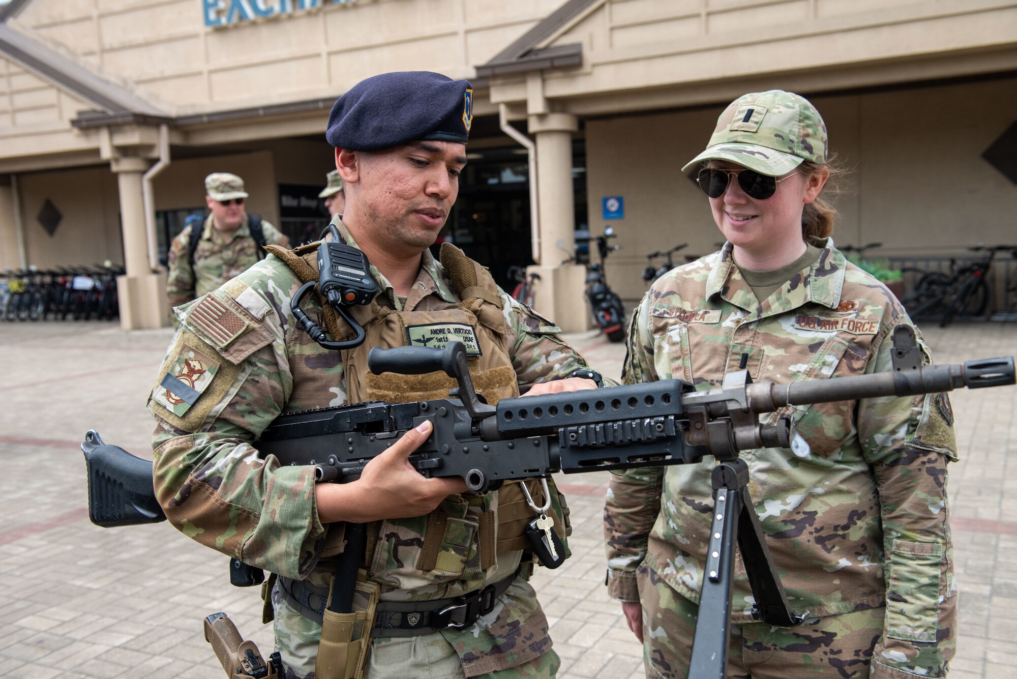 First Lt. Andre Vertucio, 8th Security Forces Squadron flight commander, teaches 1st Lt. Anna Stodola, 8th Fighter Wing executive officer, about an M240 machine gun during a Police Week 2022 Law Enforcement Exhibit at Kunsan Air Base, Republic of Korea, May 18, 2022. The 8th Security Forces Squadron took the time during Police Week to educate the Wolf Pack on the equipment they use to “Defend the Base” on a daily basis.  (U.S. Air Force Photo by Tech. Sgt. Timothy Dischinat)