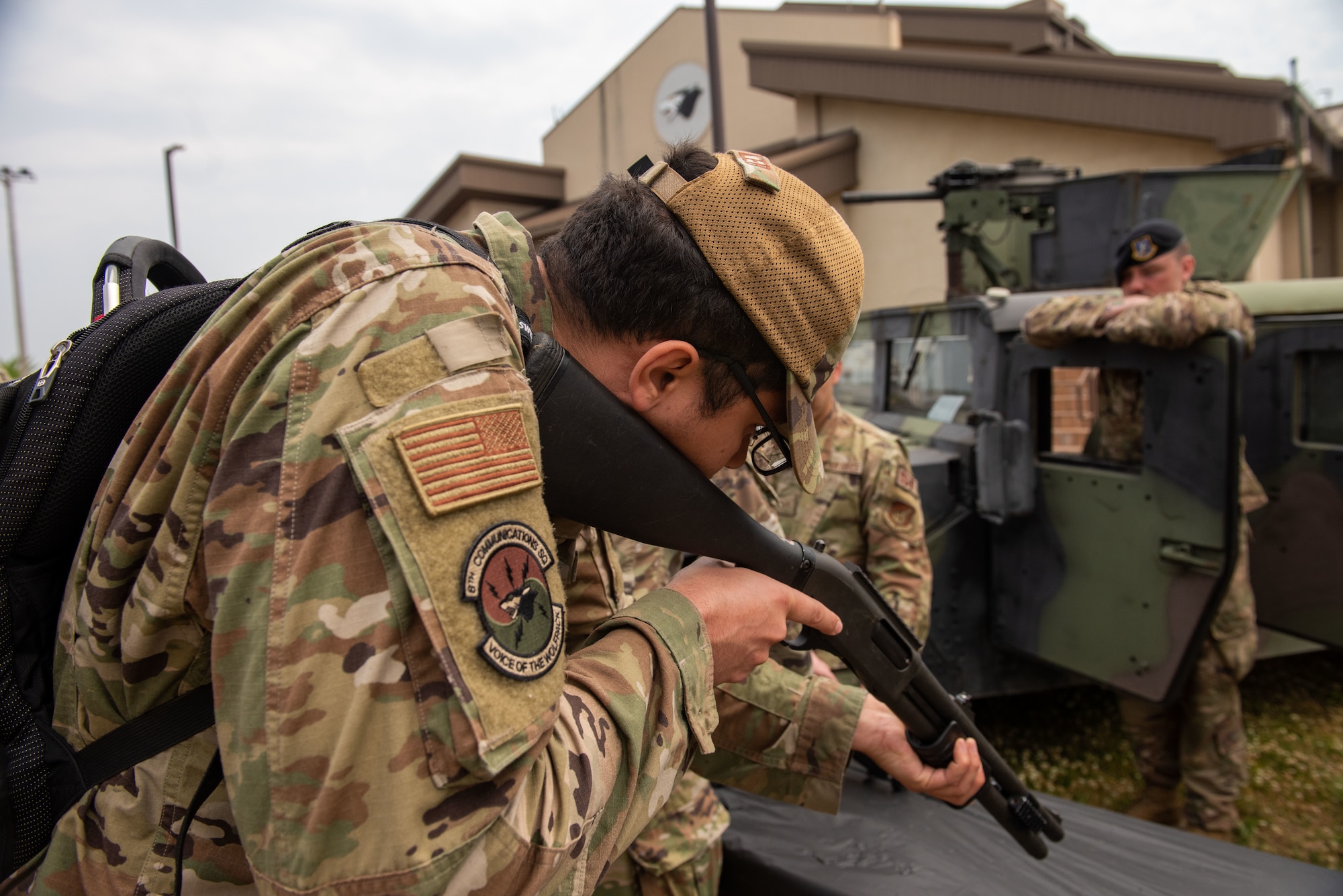 Staff Sgt. Dillen Butler, 8th Communications Squadron network operator, learns about a M870 firearm during a Police Week 2022 Law Enforcement Exhibit at Kunsan Air Base, Republic of Korea, May 18, 2022. Equipment displays allow other members of the 8th Fighter Wing to (U.S. Air Force Photo by Tech. Sgt. Timothy Dischinat)