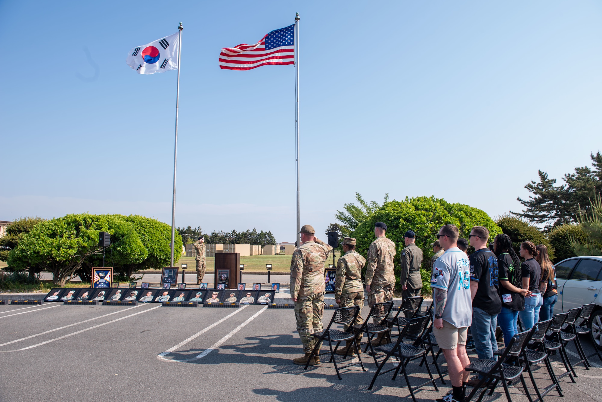 Members of the 8th Fighter Wing gather for the Police Week closing ceremony on Kunsan Air Base, Republic of Korea, May 18, 2022.  The stage of the Police Week closing ceremony pictured defenders, OSI agents and military working dogs who have lost their lives since Sept. 11, 2001.  (U.S. Air Force Photo by Tech. Sgt. Timothy Dischinat)