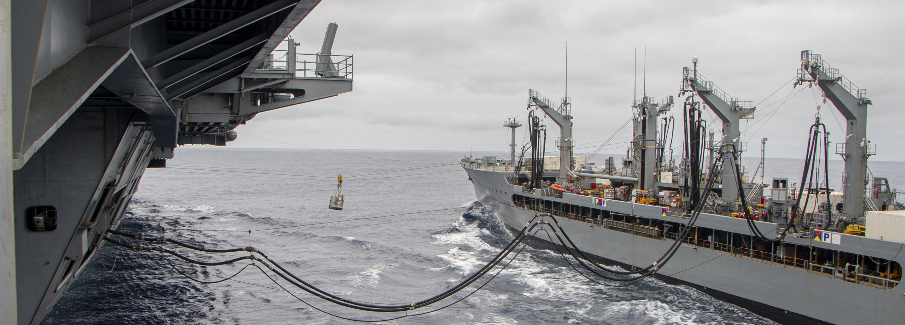 The Military Sealift Command fleet replenishment oiler USNS Henry J. Kieser (T-AO-187) steams along side the aircraft carrier USS Nimitz (CVN 68) during a replenishment at sea.