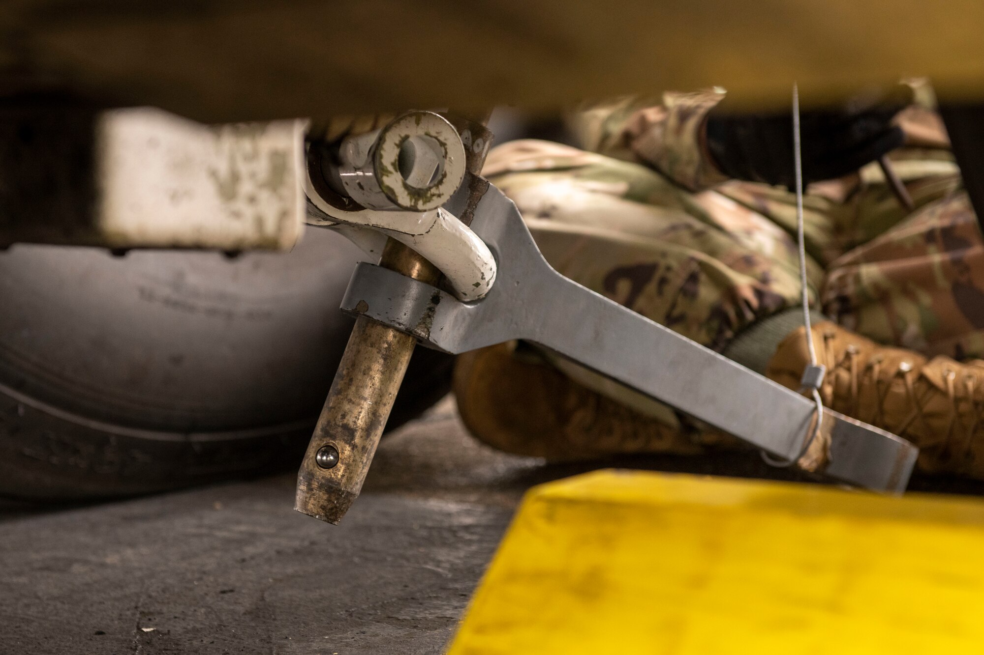 a large towing adapter hangs from a plane