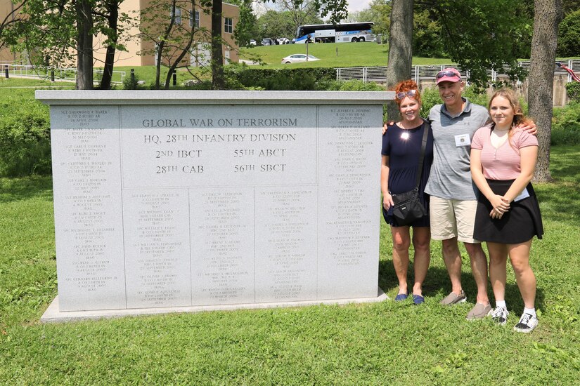 Family members of Master Sgt. Sean Thomas, a 28th Infantry Division soldier killed in Iraq in March 2007, pause for a photo next to the Global War on Terrorism monument on the grounds of the Pennsylvania Military Museum in Boalsburg, Pa. From left are Thomas' sister, Melinda Flick; his brother-in-law David Balestrini; and Thomas's daughter, Alexa Thomas.